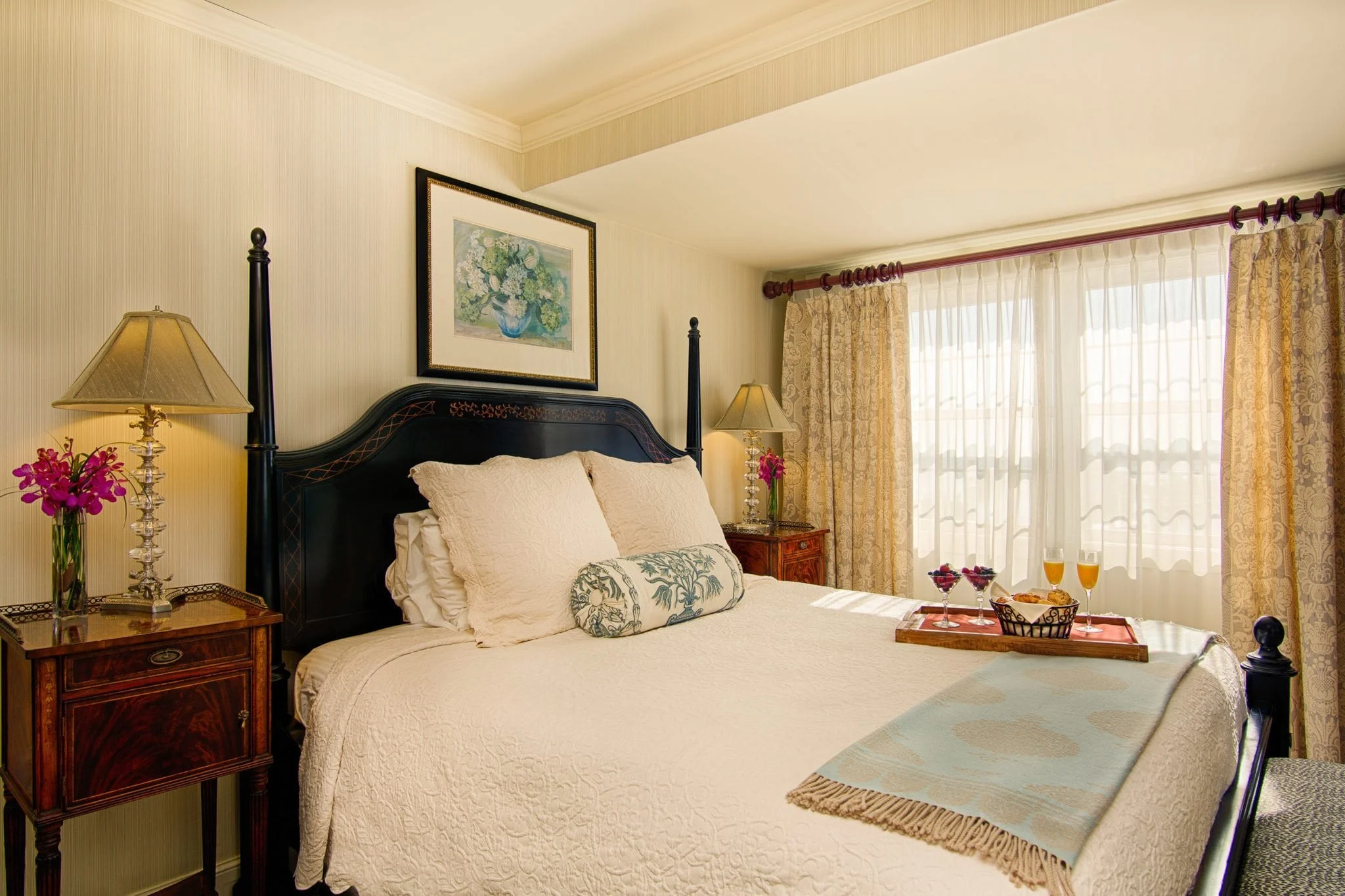 Wine and bread on tray in hotel room.