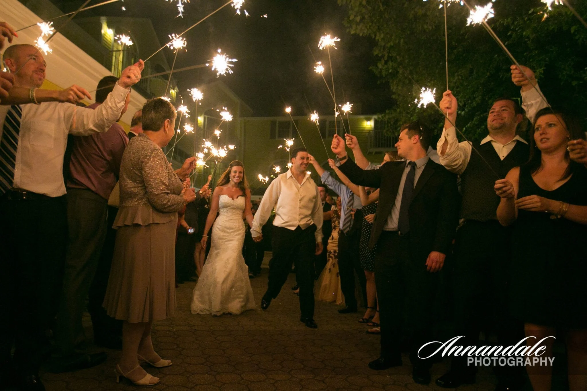 Wedding couple showered in sparklers.