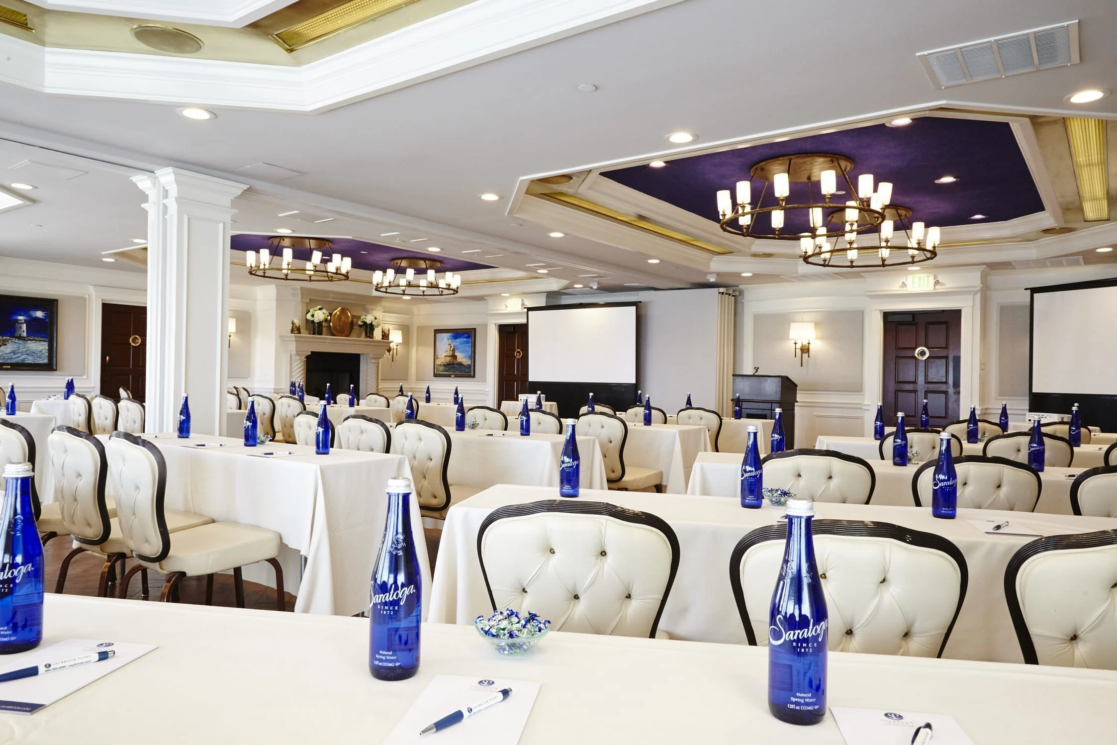 Meeting hall setup with tables and chairs.