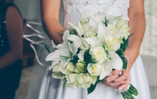 Bride holding bouquet of white flowers
